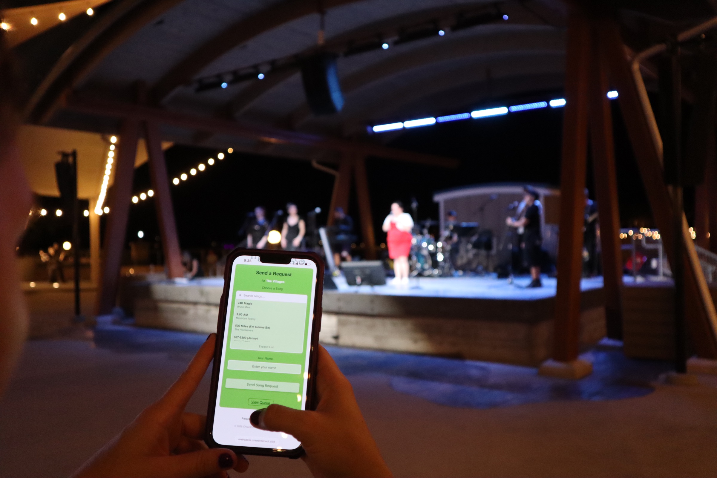 A guest sending a live song request from their phone during a concert